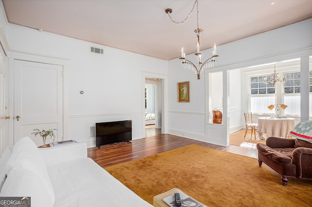 living room featuring a notable chandelier and wood-type flooring