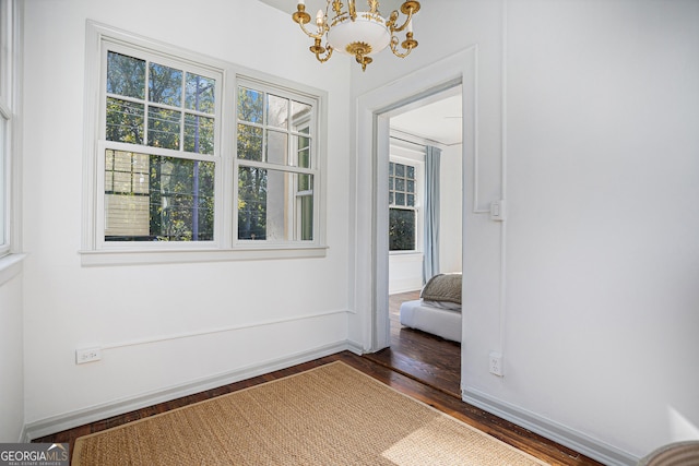 interior space featuring a chandelier and dark hardwood / wood-style floors