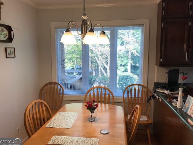 dining room featuring crown molding and a chandelier