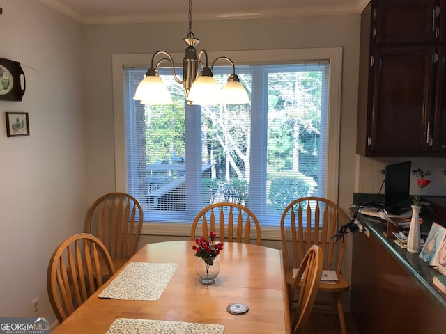 dining room featuring a notable chandelier and ornamental molding