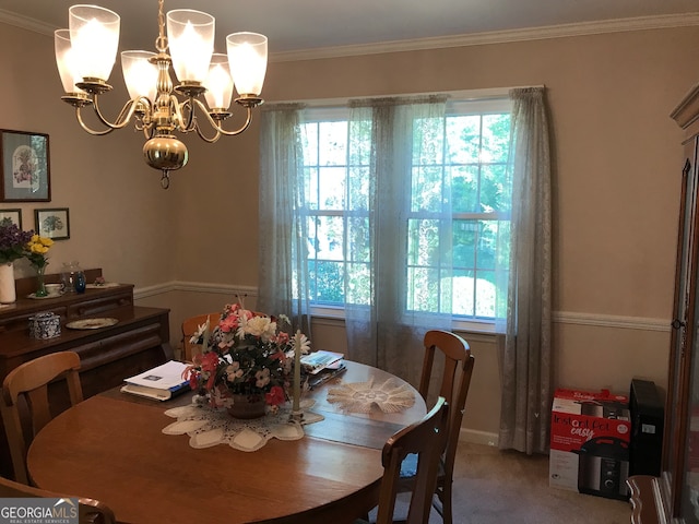 carpeted dining area with ornamental molding, a healthy amount of sunlight, and a chandelier