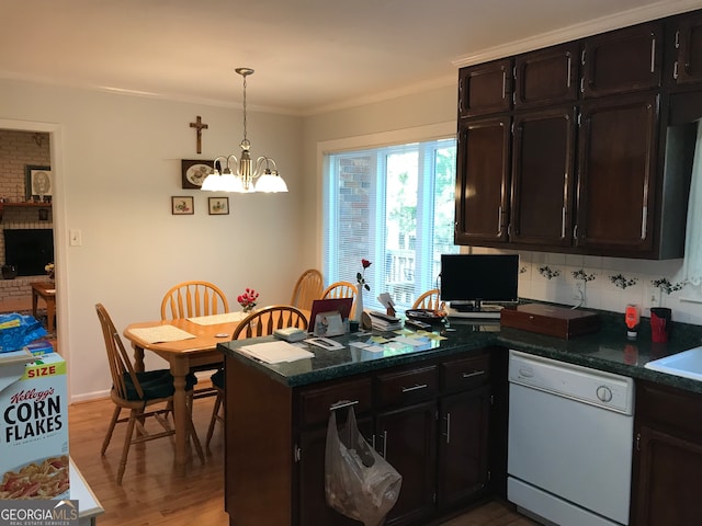 kitchen with kitchen peninsula, white dishwasher, hardwood / wood-style floors, crown molding, and pendant lighting