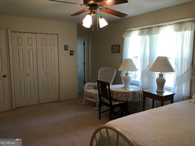 carpeted bedroom with a closet and ceiling fan