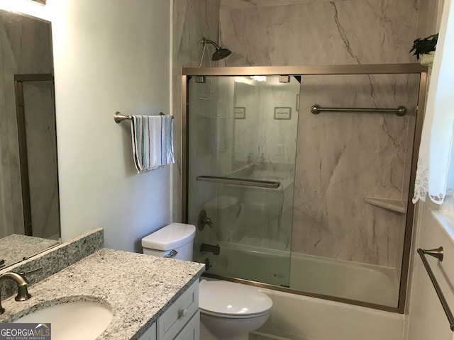 full bathroom featuring toilet, enclosed tub / shower combo, and vanity