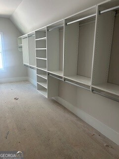 walk in closet with vaulted ceiling