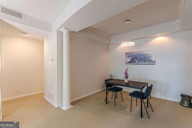 dining room featuring crown molding, carpet floors, and decorative columns