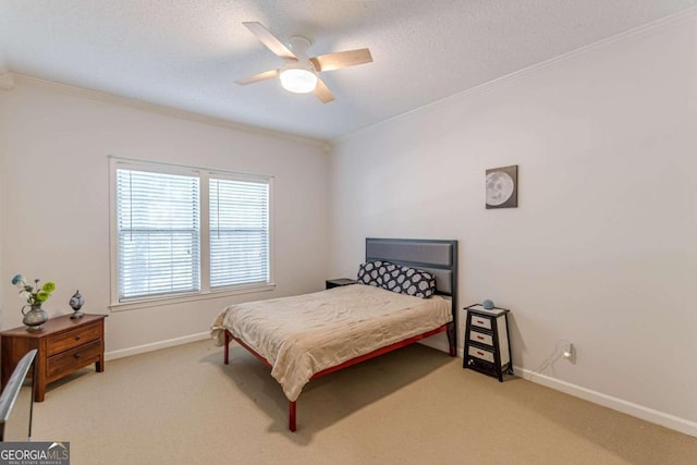 bedroom with ceiling fan, light carpet, ornamental molding, and a textured ceiling