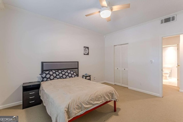 carpeted bedroom with a closet, ornamental molding, and ceiling fan