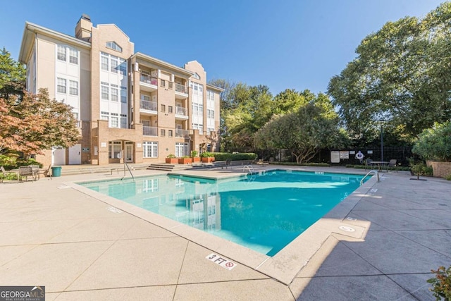 view of swimming pool with a patio area