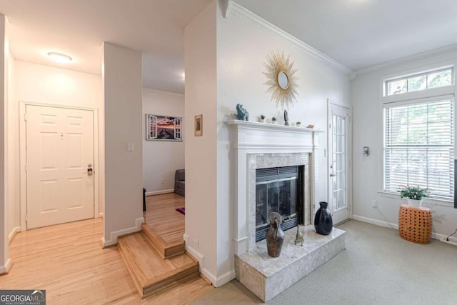 living room featuring ornamental molding, hardwood / wood-style floors, and a premium fireplace