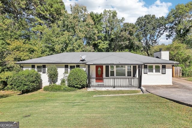 ranch-style house with a front yard and covered porch