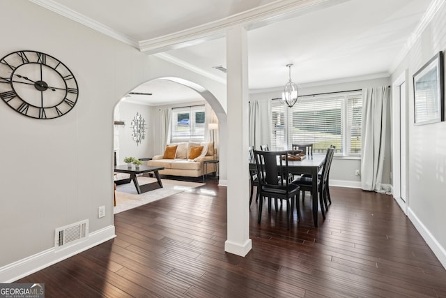 dining room with crown molding, a notable chandelier, and dark hardwood / wood-style flooring