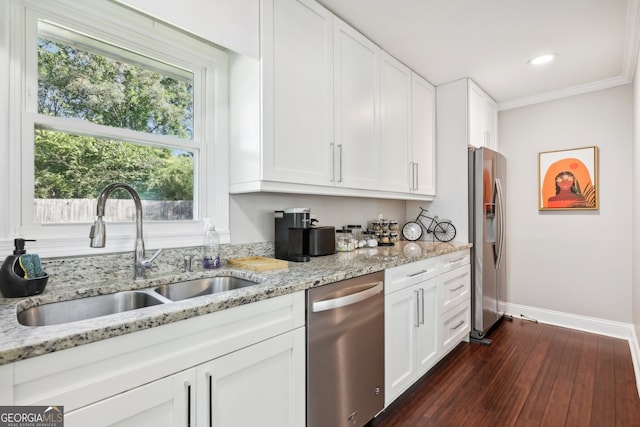 kitchen with white cabinets, appliances with stainless steel finishes, dark hardwood / wood-style floors, crown molding, and sink