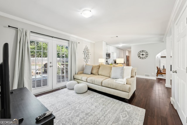 living room with french doors, crown molding, and dark hardwood / wood-style flooring