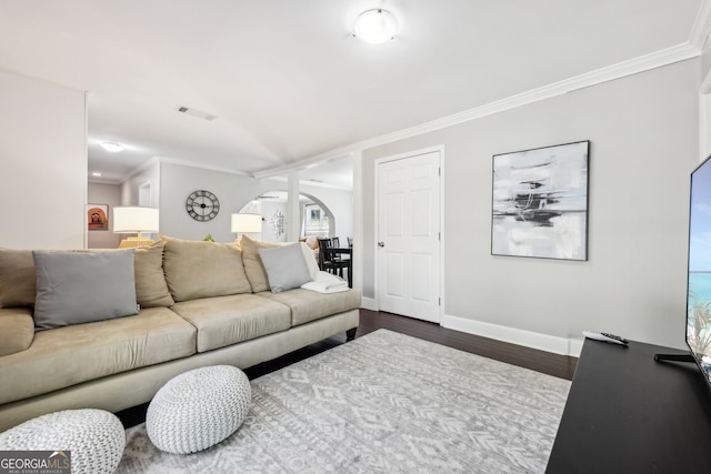 living room featuring a wealth of natural light, crown molding, and dark hardwood / wood-style flooring