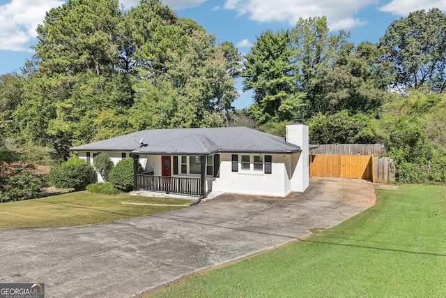 single story home with covered porch and a front yard