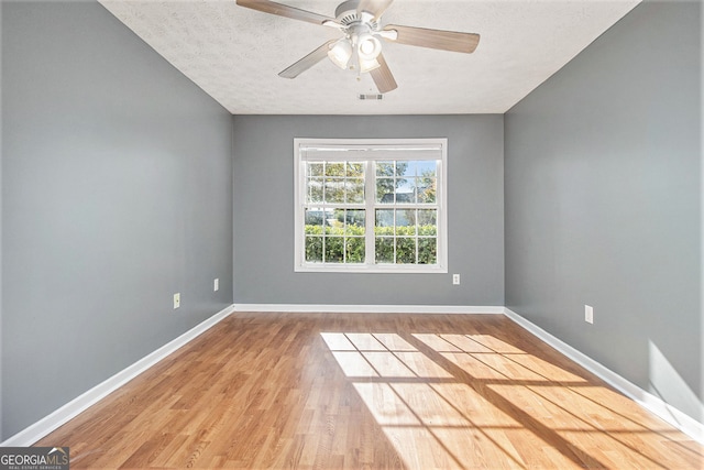 unfurnished room with hardwood / wood-style floors, a textured ceiling, and ceiling fan