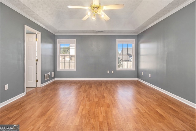 spare room with ceiling fan, light hardwood / wood-style flooring, and ornamental molding