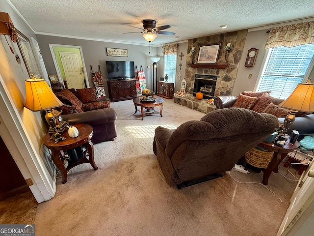 living room with ceiling fan, a stone fireplace, a textured ceiling, and light colored carpet