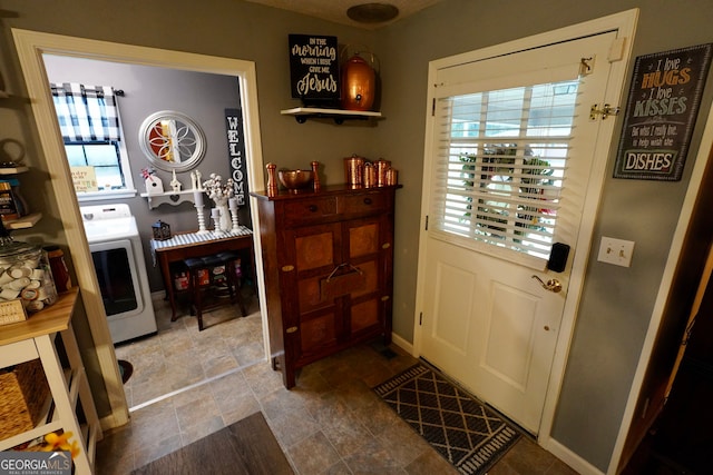 doorway to outside featuring a wealth of natural light and washer / dryer