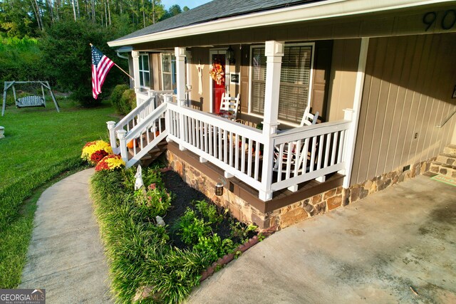 deck with a yard and covered porch