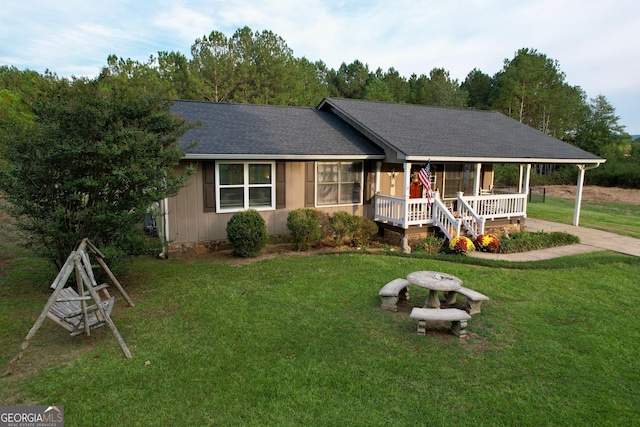 ranch-style house featuring a porch and a front lawn