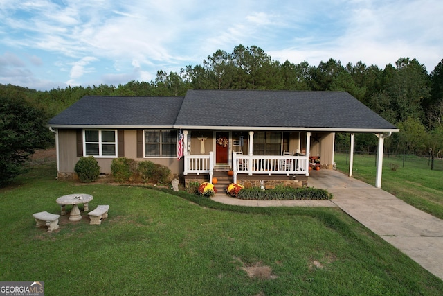 single story home with a porch, a front lawn, and a carport