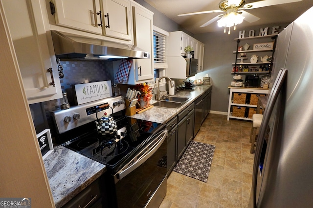 kitchen with appliances with stainless steel finishes, sink, ceiling fan, white cabinets, and decorative backsplash