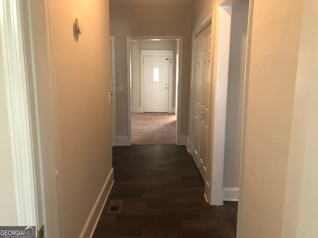 hallway with dark hardwood / wood-style flooring