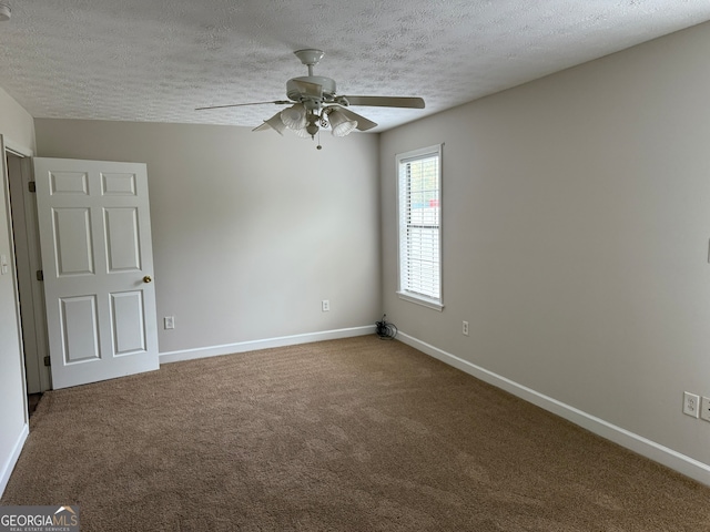 unfurnished room featuring a textured ceiling, carpet floors, and ceiling fan