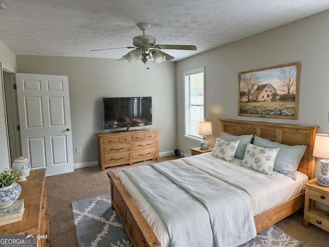 bedroom with ceiling fan, a textured ceiling, and dark carpet