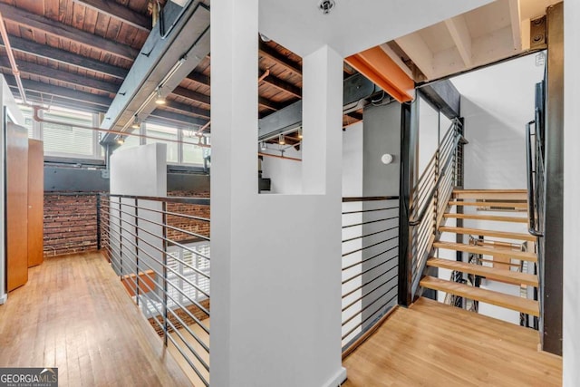 interior space featuring beamed ceiling, wood-type flooring, and wooden ceiling