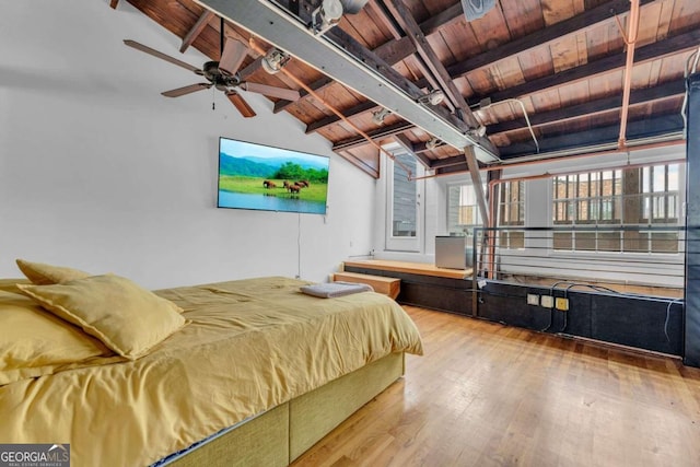 bedroom featuring hardwood / wood-style floors, lofted ceiling with beams, and wood ceiling