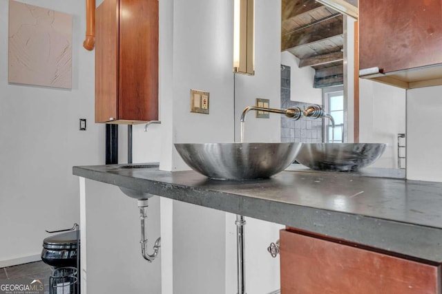 interior details featuring wood ceiling, beam ceiling, and sink