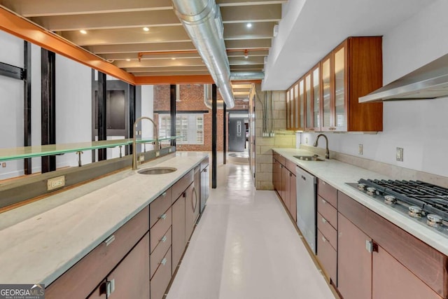 kitchen featuring beamed ceiling, sink, appliances with stainless steel finishes, and light stone counters