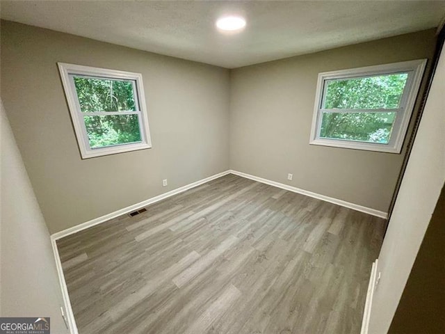 unfurnished room featuring light hardwood / wood-style floors