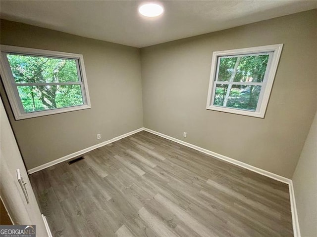 unfurnished room featuring hardwood / wood-style flooring