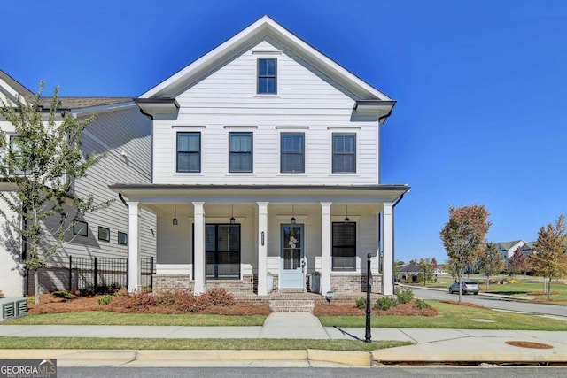view of front facade featuring a porch and brick siding