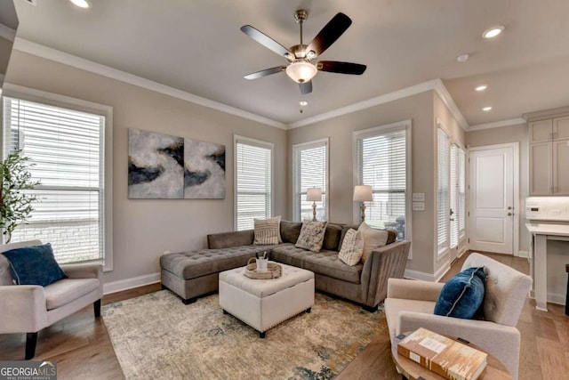 living room with a ceiling fan, baseboards, a wealth of natural light, and light wood-style floors
