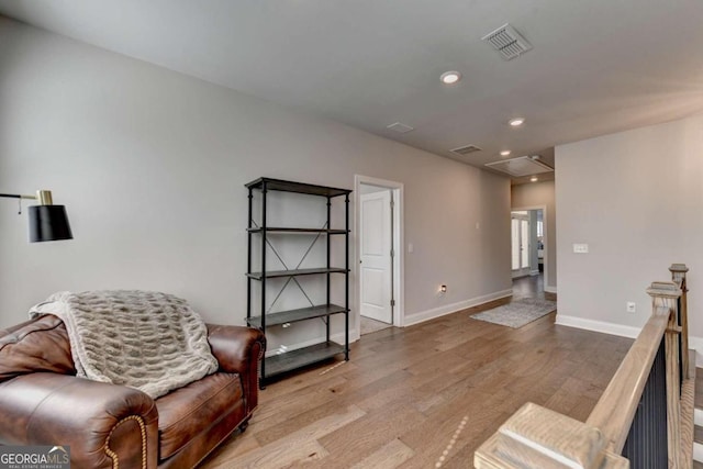 sitting room with recessed lighting, light wood-style flooring, visible vents, and baseboards