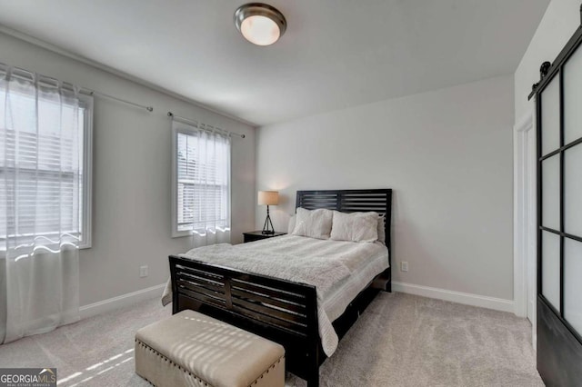 carpeted bedroom with a barn door