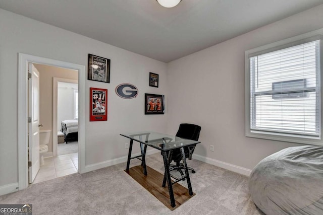 bedroom with baseboards and light colored carpet