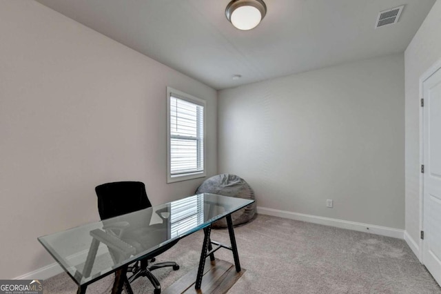 office area featuring baseboards, visible vents, and carpet