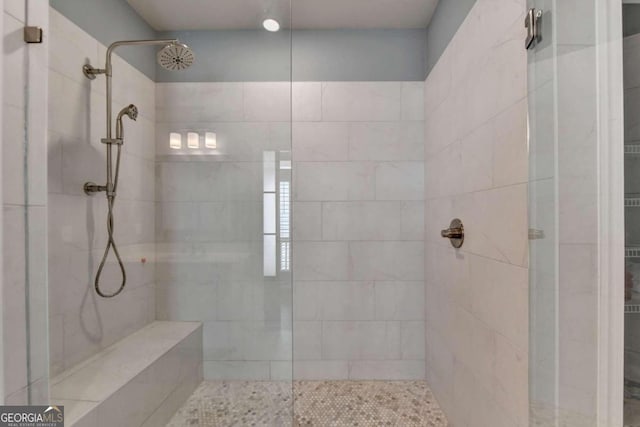 bathroom featuring a tile shower