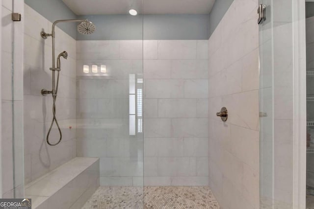 bathroom with a tile shower