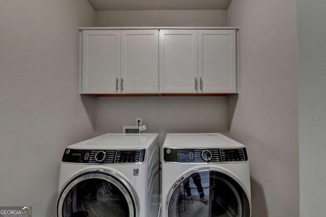 laundry area with washing machine and dryer and cabinet space