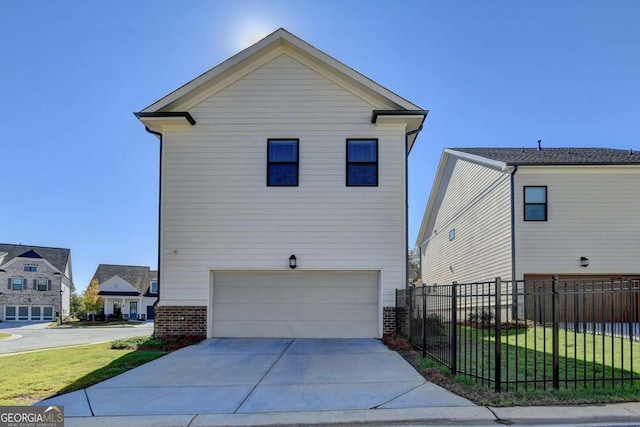 exterior space featuring fence, driveway, a yard, and a garage