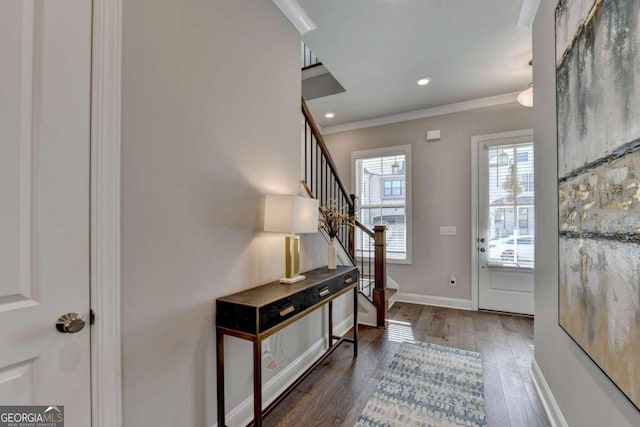 foyer entrance featuring stairway, crown molding, wood finished floors, baseboards, and recessed lighting