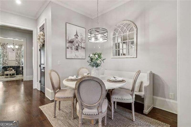 dining area featuring a chandelier and dark hardwood / wood-style flooring