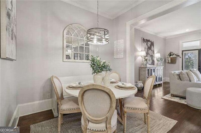 dining room featuring a notable chandelier, crown molding, and dark wood-type flooring